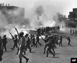 FILE - Ohio National Guard moves in on rioting students at Kent State University in Kent, Ohio, May 4, 1970. Four persons were killed and 11 wounded when National Guardsmen opened fire.