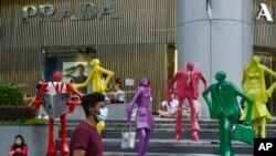 People wearing protective face masks walk along the Orchard Road shopping area in Singapore on Nov. 28, 2021. 