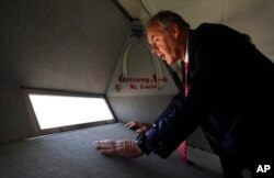 U.S. Interior Secretary Ryan Zinke looks out a window at the top of the Gateway Arch, July 3, 2018, in St. Louis.