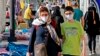 Iranians wearing face masks walk at a market in the capital Tehran on June 3, 2020, amid the novel coronavirus pandemic crisis. - The spread of novel coronavirus has accelerated again this month in Iran which today officially confirmed over 3,000…