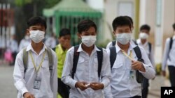 FILE: Students wear masks to avoid the contact of coronavirus at a high school in Phnom Penh, Cambodia, Tuesday, Jan. 28, 2020. (AP Photo/Heng Sinith) 