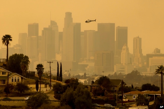 The sky is filled with smoke from multiple wildfires around the Los Angeles skyline, Jan. 9, 2025.