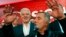 FILE - Montenegro's Prime Minister and long-ruling Democratic Party of Socialists leader Milo Djukanovic, front, speaks in his headquarters while his deputy, Dusko Markovic, stands behind him in Podgorica, Montenegro, Oct. 17, 2016.