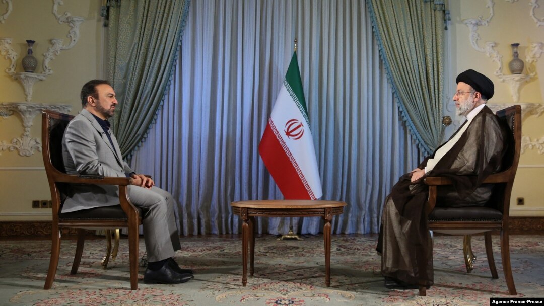 A handout picture provided by the Iranian presidency on Oct. 18, 2021 shows Iranian president Ebrahim Raisi during and interview with an Iranian TV channel. (Iranian Presidency / AFP)