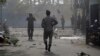 Sri Lankan security forces approach the site after a vehicle parked near St. Anthony's shrine exploded in Colombo, Sri Lanka, April 22, 2019.