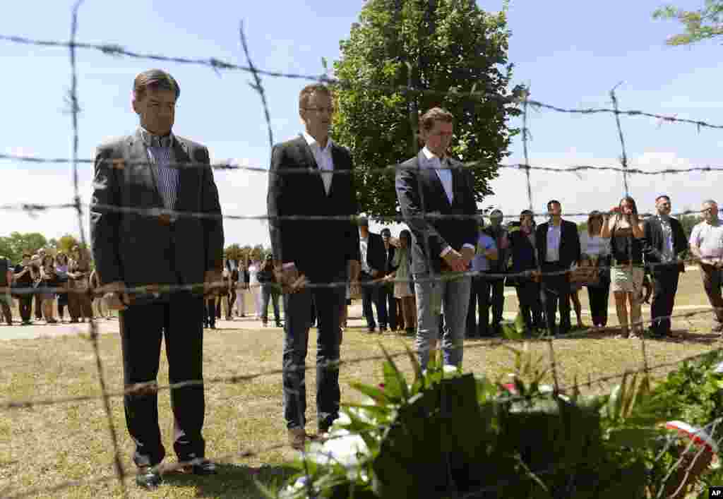 From left, Slovakian FMr Miroslav Lajcak, State Secretary of the Hungarian Ministry of Foreign Affairs and Trade Peter Szijjarto and Austrian FM Sebatian Kurz bow their heads at a monument, a remaining part of the former barbed wire fence, as they mark the 25th anniversary of the beginning of the dismantling of the Iron Curtain between Hungary and Austria at Sopronkohida, 208 kms west of Budapest. 