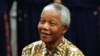 FILE - Nelson Mandela prepares to shoot a basketball hoop with the Harlem Globetrotters as part of his birthday celebrations, July 4, 1997.