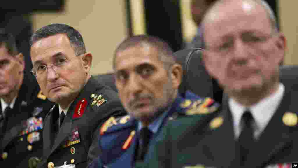 Turkish Lt. Gen. Erdal Ozturk, second from left, and others, listen as President Barack Obama speaks during a meeting with more than 20 foreign defense ministers on the ongoing operations against the Islamic State group, Andrews Air Force Base, Maryland, 
