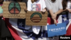 Supporters hold signs as President Barack Obama speaks during a campaign event at Capital University in Columbus, Ohio, August 21, 2012.