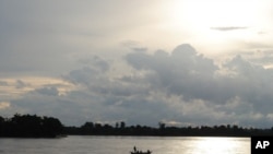 A fishing boat floats on the Mekong river.