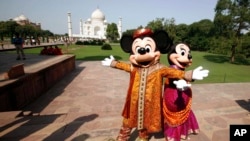 FILE - Walt Disney cartoon characters Mickey Mouse (L) and Minnie Mouse pose at the Taj Mahal in Agra, India, Oct. 30, 2008. Disney staged its first Broadway show in India in Mumbai in 2012.