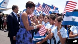 President Barack Obama and First Lady Michelle Obama shake hands with children along the ropeline at the arrival ceremony at Comalapa International Airport in San Salvador, El Salvador, March 22, 2011. (Official White House Photo by Pete Souza)