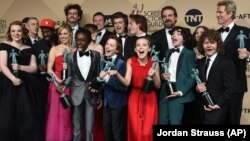 The cast and crew of "Stranger Things" pose in the press room with the award for outstanding performance by an ensemble in a drama series at the 23rd annual Screen Actors Guild Awards on Sunday, Jan. 29, 2017. (Photo by Jordan Strauss/Invision/AP)
