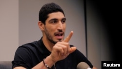 Turkish NBA player Enes Kanter talks with reporters at National Basketball Players Association headquarters in New York, May 22, 2017. 