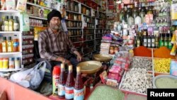 FILE - Afghan Sikh Jagtar Singh Laghmani, 50, sits at his traditional herb shop in Kabul, Afghanistan. 