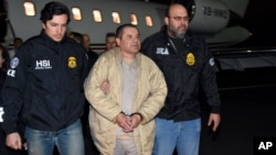 In this photo provided by U.S. law enforcement, authorities escort Joaquin "El Chapo" Guzman, center, from a plane to a waiting caravan of SUVs at Long Island MacArthur Airport, Jan. 19, 2017, in Ronkonkoma, N.Y.