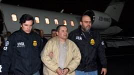 In this photo provided U.S. law enforcement, authorities escort Joaquin