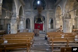 This photograph shows the inside of the church of Saint Shmoni, damaged by Islamic State fighters, in Bartella, Iraq, Oct. 22, 2016.