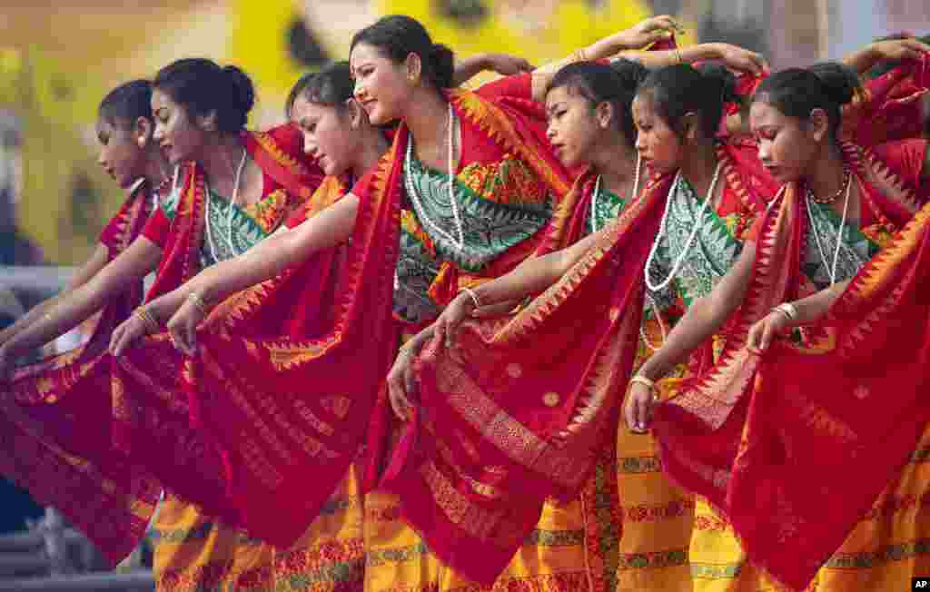 Indian Bodo tribal girls dance at an event to celebrate signing of a peace accord with the Bodo rebel group, National Democratic Front of Bodoland, in Kokrajhar, a town 250 kilometers (150 miles) west of Gauhati, India.