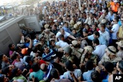 Egyptian Army soldiers respond to clashes between supporters and opponents of ousted President Mohammed Morsi in Alexandria, Egypt, Friday, Sept. 13, 2013.