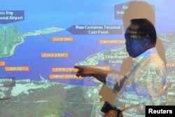 FILE - Subic Bay Metropolitan Authority (SBMA) chairman Roberto Garcia points at a map of Subic Bay during a forum in Subic Bay, Zambales province, north of Manila, Sept. 25, 2015.