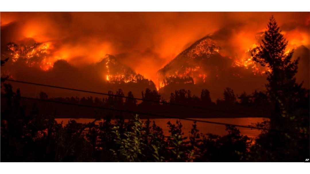 FILE - The Eagle Creek Fire, as seen from near Stevenson Wash., across the Columbia River, burns in the Columbia River Gorge above Cascade Locks, Ore., Sept. 4, 2017.
