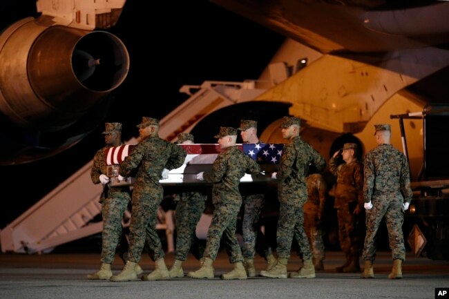 A U.S. Marine Corps carry team moves a transfer case containing the remains of Staff Sgt. Christopher A. Slutman, April 11, 2019, at Dover Air Force Base, Del.