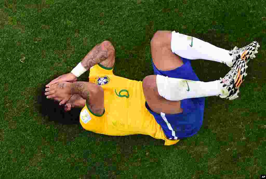 Brazil's Marcelo lies on the pitch during the World Cup semifinal soccer match between Brazil and Germany at the Mineirao Stadium in Belo Horizonte, Brazil, July 8, 2014.