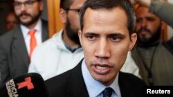 FILE - Venezuelan opposition leader and self-proclaimed interim president Juan Guaido talks to the media before a session of the Venezuela’s National Assembly in Caracas, Jan. 29, 2019.