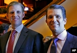 Eric Trump, left, and Donald Trump Jr., executive vice presidents of The Trump Organization, pose for a photograph at an event for Scion Hotels, a division of Trump hotels, June 5, 2017, in New York.