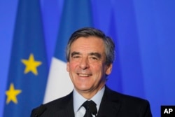 French conservative presidential candidate Francois Fillon smiles during a speech on defense policy, March 31, 2017 in Paris.