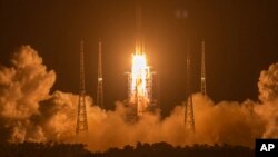 FILE - In this Nov. 24, 2020, photo, a Long March-5 rocket carrying the Chang'e 5 lunar mission lifts off at the Wenchang Space Launch Center in Wenchang in southern China's Hainan Province.