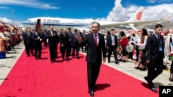 In this photo released by Xinhua News Agency, Wang Yang, center, waves as he arrives in Lhasa to attend the ceremony to commemorate the 70th anniversary of Tibet liberation, in Lhasa in western China's Tibet Autonomous Region on Wednesday, Aug. 18, 2021. 