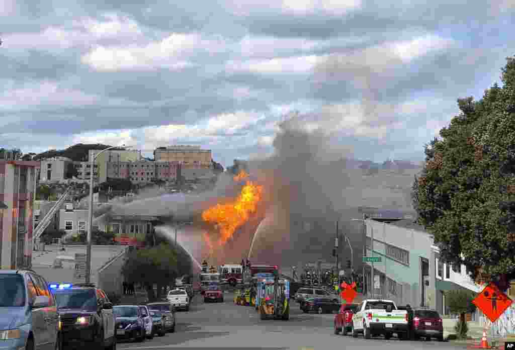 Flames rage at an intersection in San Francisco, Feb. 6, 2019. An explosion on a gas line has set at least one San Francisco building on fire and is sending huge plumes of fire and smoke into the air, prompting evacuations of nearby buildings.