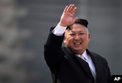 North Korean leader Kim Jong Un waves during a military parade in Pyongyang, North Korea, April 15, 2017.