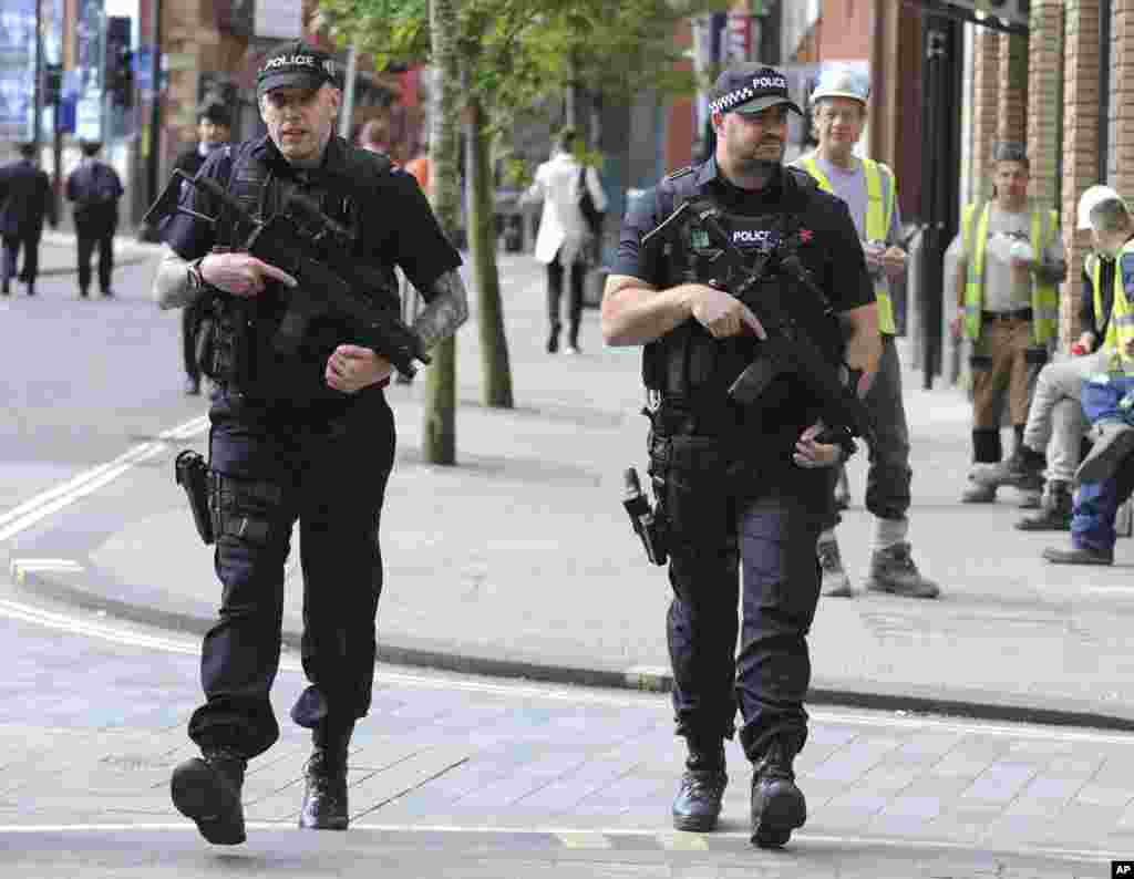 Armed police patrol the streets near to Manchester Arena in central Manchester, England, May 23, 2017. 