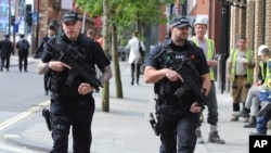 Armed police patrol the streets near to Manchester Arena in central Manchester, England, May 23, 2017. 