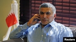 Bahrain human rights activist Nabeel Rajab talks on his mobile phone upon arriving home in Budaiya, west of Manama, after being detained for over two weeks, May 28, 2012.