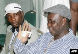 FILE - Tom Ateke, one of Nigeria's key militant leaders, speaks with Government Ekpemupolo known as Tompolo (L), commander of the rebel Movement for the Emancipation of the Niger Delta (MEND), during their meeting in Abuja, Oct. 9, 2009.