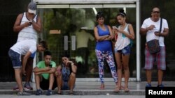 FILE - Cubans use the internet via public Wi-Fi in Havana, Cuba, Sept. 5, 2016. By the end of the year, Cuba promises to bring the internet to homes in Old Havana. 