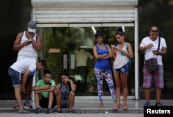 FILE - Cubans use the internet via public Wi-Fi in Havana, Cuba, Sept. 5, 2016. By the end of the year, Cuba promises to bring the internet to homes in Old Havana.