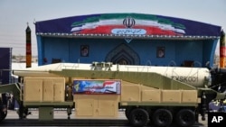 FILE - Iran's Khoramshahr missile is displayed by the Revolutionary Guards during a military parade outside Tehran, Sept. 22, 2017.