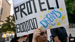 FILE - An unidentified student joins a rally in support of the Deferred Action for Childhood Arrivals, or DACA, program outside the Edward Roybal Federal Building in downtown Los Angeles, Sept. 1, 2017.