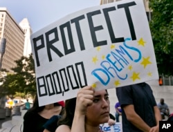 FILE - An unidentified student joins a rally in support of the Deferred Action for Childhood Arrivals, or DACA program, outside the Edward Roybal Federal Building in downtown Los Angeles, Sept. 1, 2017.