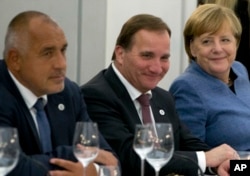 German Chancellor Angela Merkel, right, sits with Swedish Prime Minister Stefan Lofven, center, and Bulgarian Prime Minister Bokyo Borisov during an informal dinner ahead of an EU Digital Summit in Tallinn, Estonia, Sept. 28, 2017.