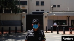 A police officer stands guard in front of the former U.S. Consulate General in Chengdu, Sichuan province, China, July 27, 2020, after China ordered its closure. (REUTERS/Thomas Peter)