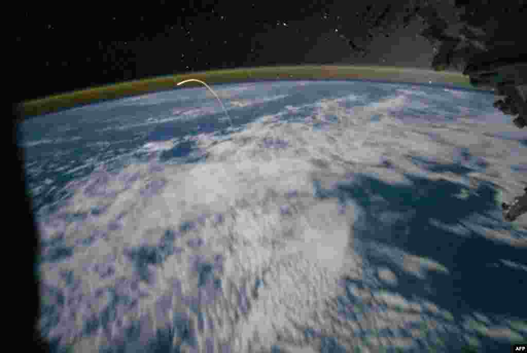 July 21: The space shuttle Atlantis returns to earth, photographed by the crew of the International Space Station. Atlantis and four astronauts returned from the International Space Station Thursday, bringing an end to NASA's 30-year shuttle journey. (AP