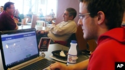 In this April 18, 2013, photo sophomore Mike Ziehr looks at his computer in the student union at the University of Wisconsin at Madison.