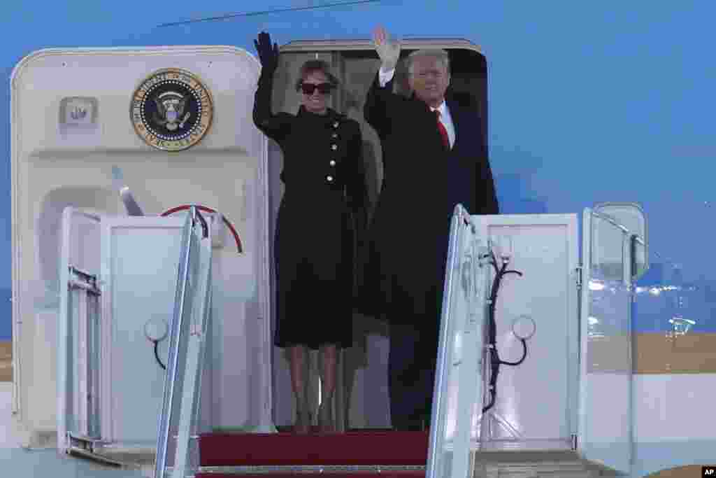President Donald Trump and first lady Melania Trump wave to a crowd as they board Air Force One at Andrews Air Force Base, Maryland.