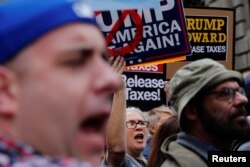 Demonstrators march past Trump Tower as they protest through Manhattan demanding U.S. President Donald Trump release his tax returns, in New York, April 15, 2017.